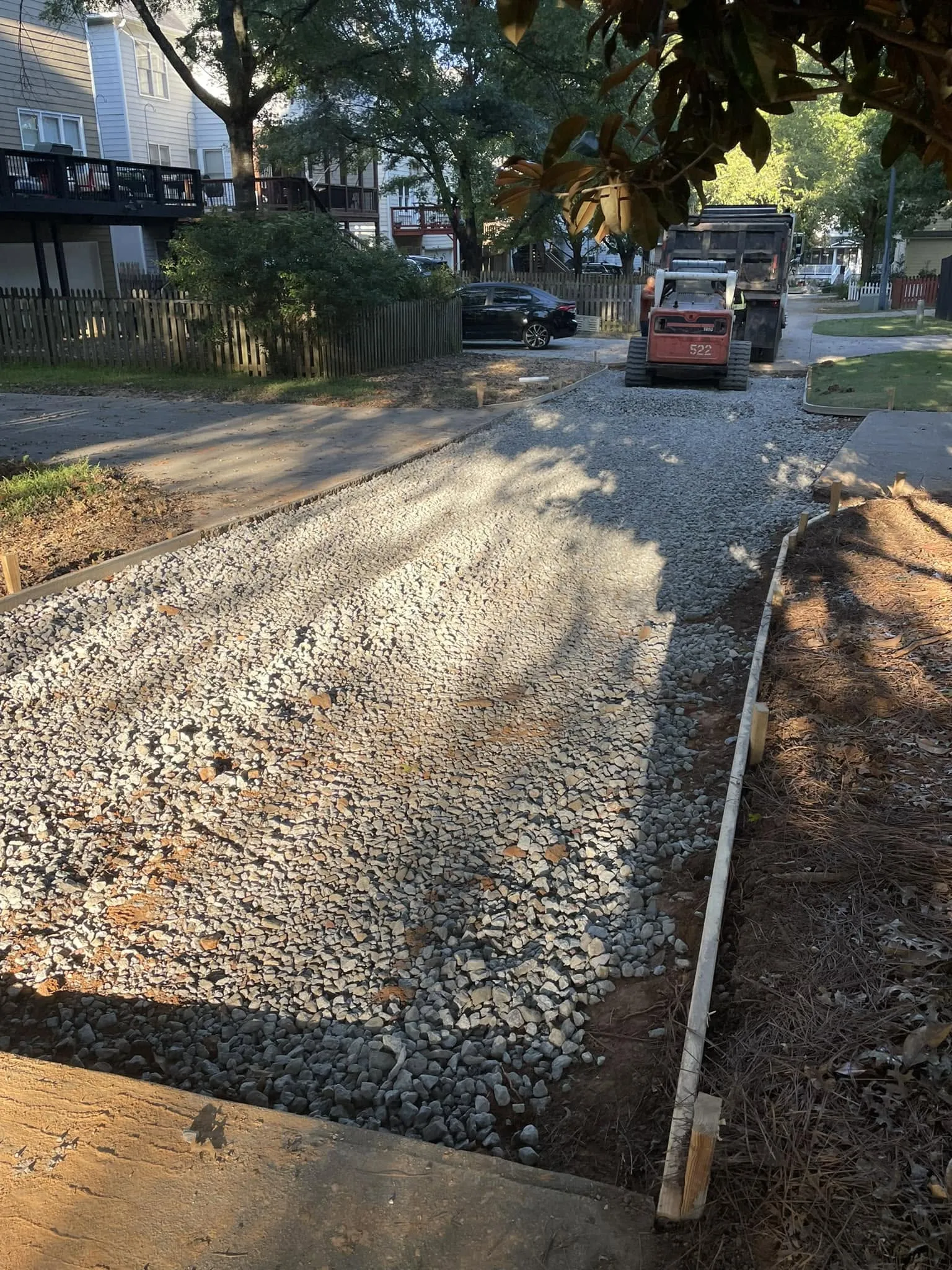 Compacted gravel base prepared for a driveway pour in Atlanta