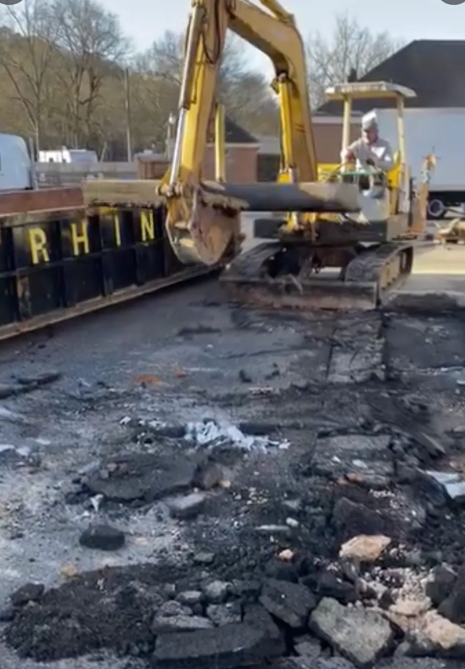 Excavator grading a building pad on a North Georgia job site